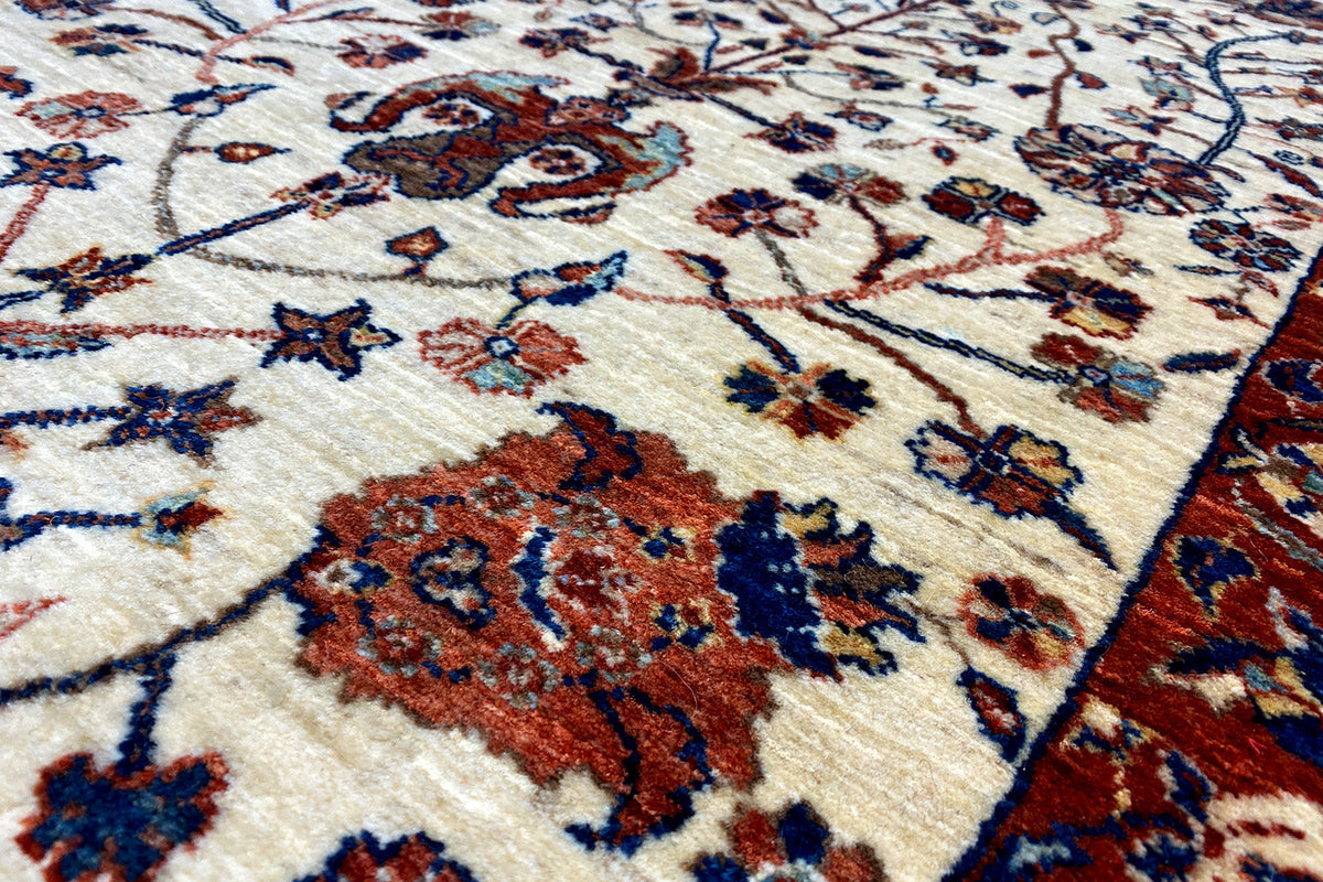 Qashqai exclusive carpet close-up, cream base with red and blue floral ornamentation