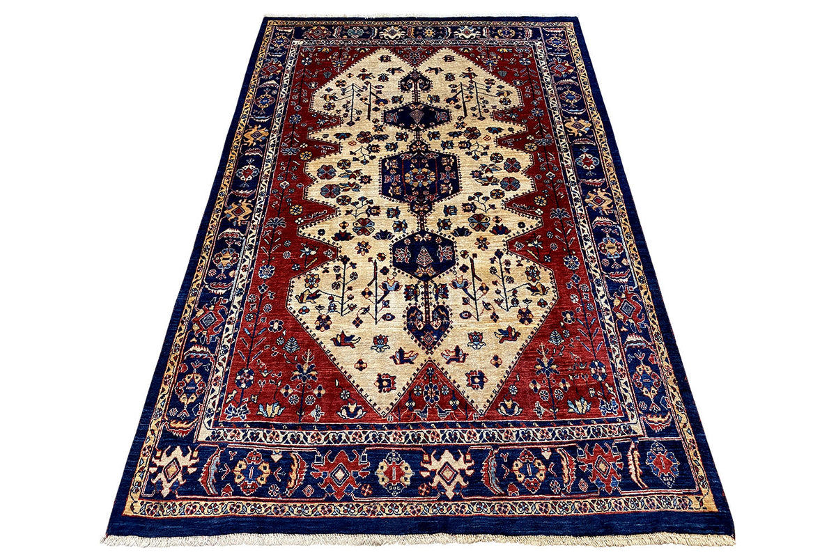 Qashqai Exclusive rectangular Oriental rug: cream-colored central motif, red field, blue borders