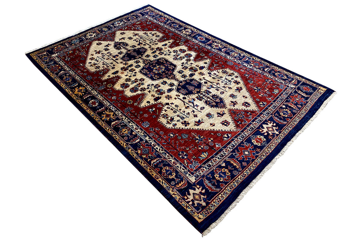 Qashqai exclusive oriental rug, diagonal: cream-white medallion on a red background with blue decorative borders