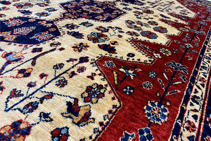 Oriental rug pattern: cream and red with a blue design, woven pile and bordered edge