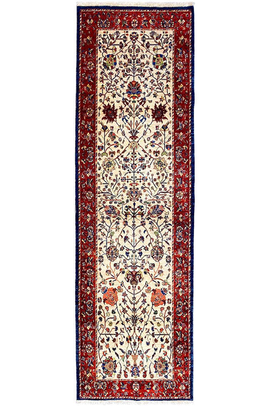 Oriental rug runner with a red border, cream-colored central field, and tile ornaments