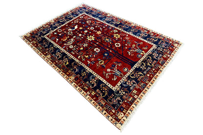 Oriental rug with a border-style design, dark blue with a red field and ornaments