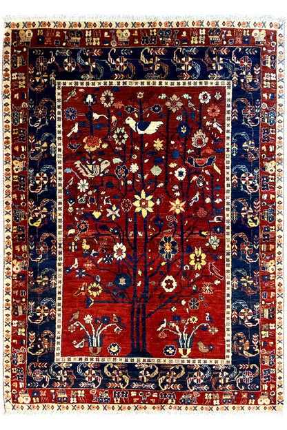 Oriental rug with a red central medallion, blue border, and floral ornamentation