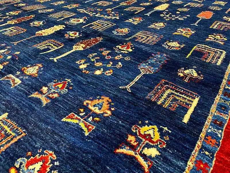 Carpet surface in detail: blue base fabric with colorful geometric motifs