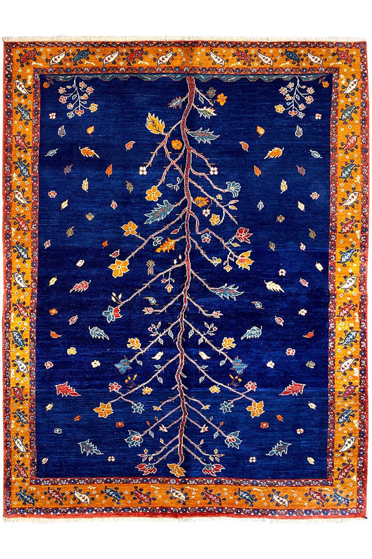 Rectangular Oriental rug: dark blue with a gold-orange border and delicate tree motif