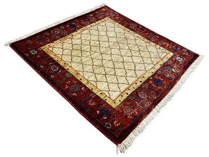 Square rug viewed from above, beige grid in the center, red border around the edges
