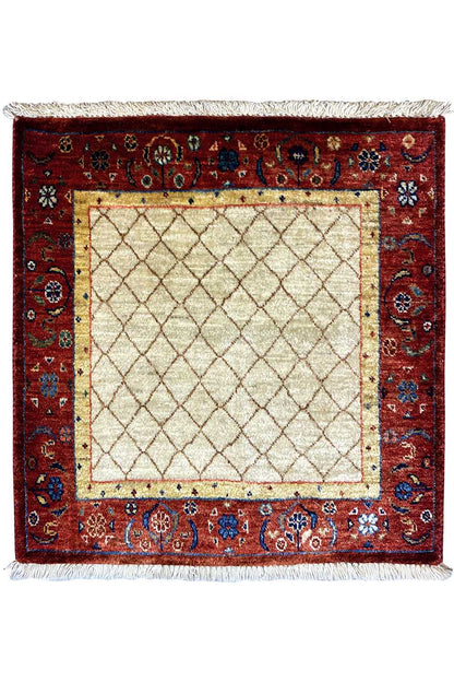 Square rug with a red border and beige central square, white fringes