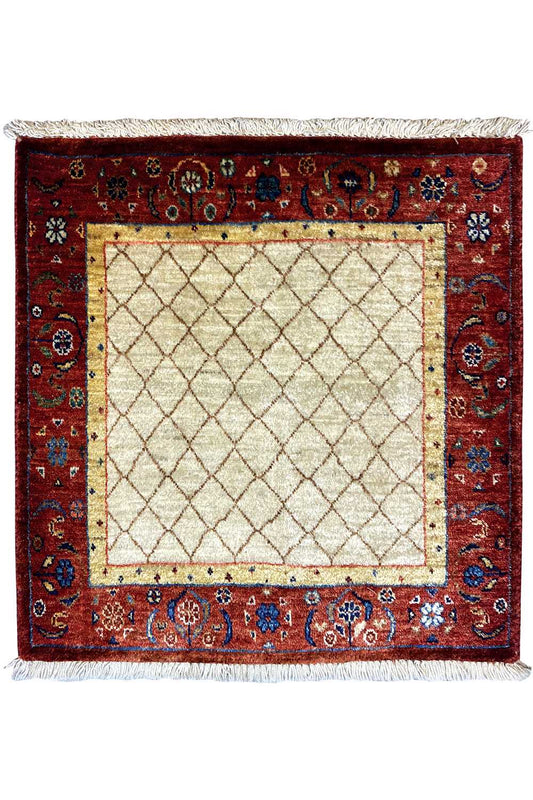Square rug with a red border and beige central square, white fringes