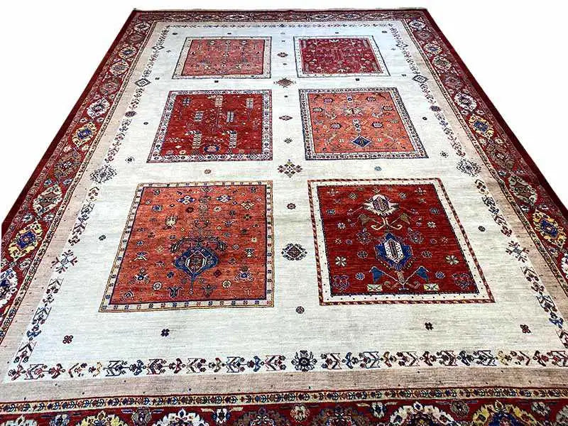 Rug with a light beige ground and eight red and blue tile medallions