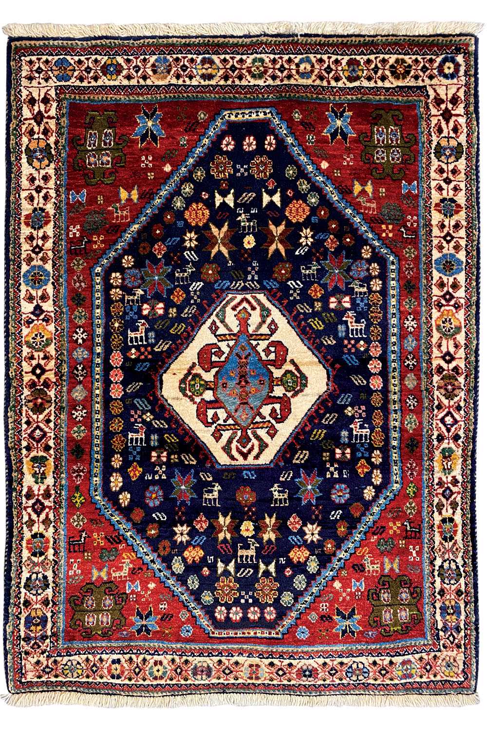 Oriental rug with a red border, blue center, and geometric central medallion