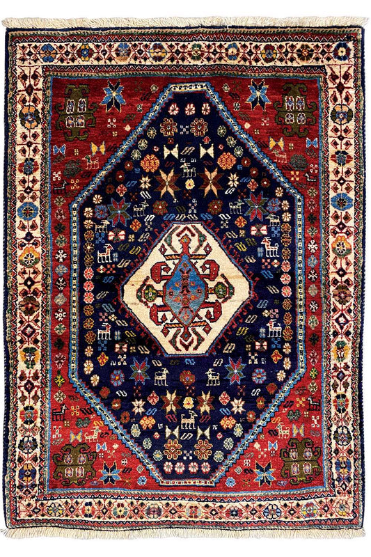 Oriental rug with a red border, blue center, and geometric central medallion