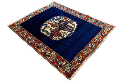 Blue carpet with a central medallion and multicolored border, diagonal view
