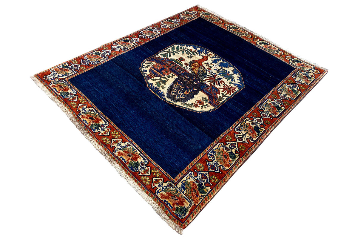 Blue carpet with a square inner field, central medallion, and red border