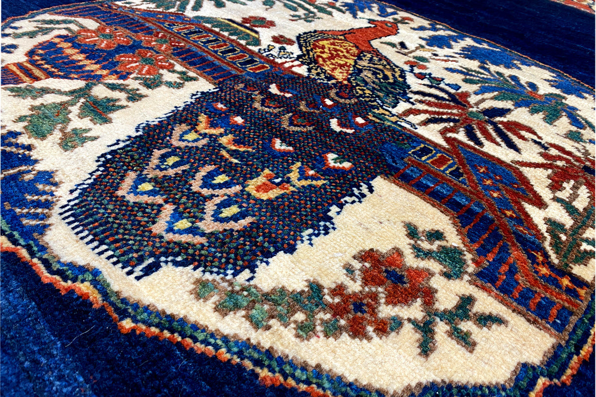 Close-up details of the rug pattern: blue, beige, and colorful ornaments