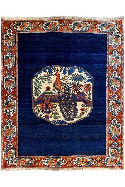 Blue rug 178x143 cm with red ornamental border and medallion design