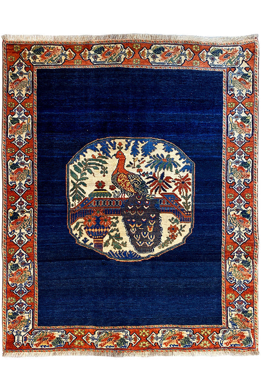 Blue rug 178x143 cm with red ornamental border and medallion design