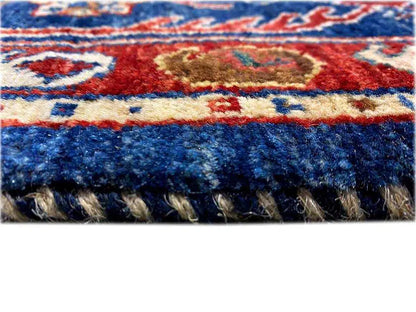 Oriental rug detail: colorful woven patterns at the edge with fringes