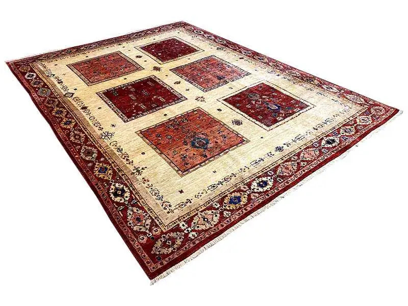 Oriental rug with square red tones and a beige background, diagonal view