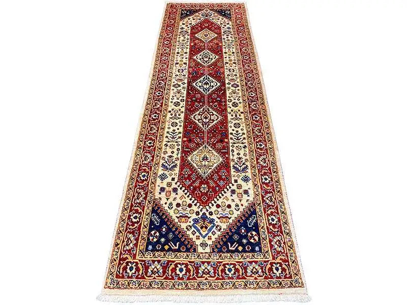 Runner rug with a red border, blue inner pattern, and fringes at both ends