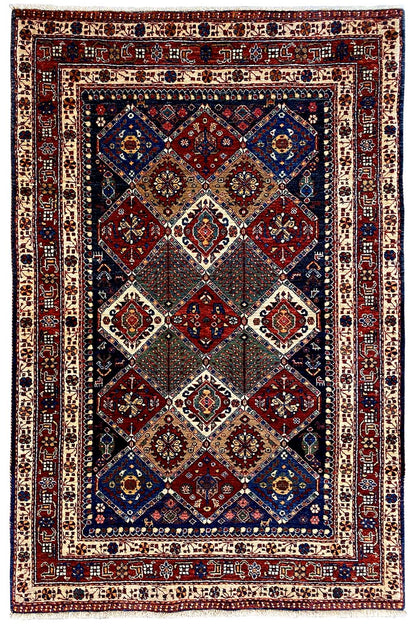 Oriental rug with central diamonds, a red-blue central field, and a geometric border