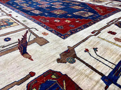 Close-up of an oriental rug with red, blue, and cream-colored motifs, detailed contours
