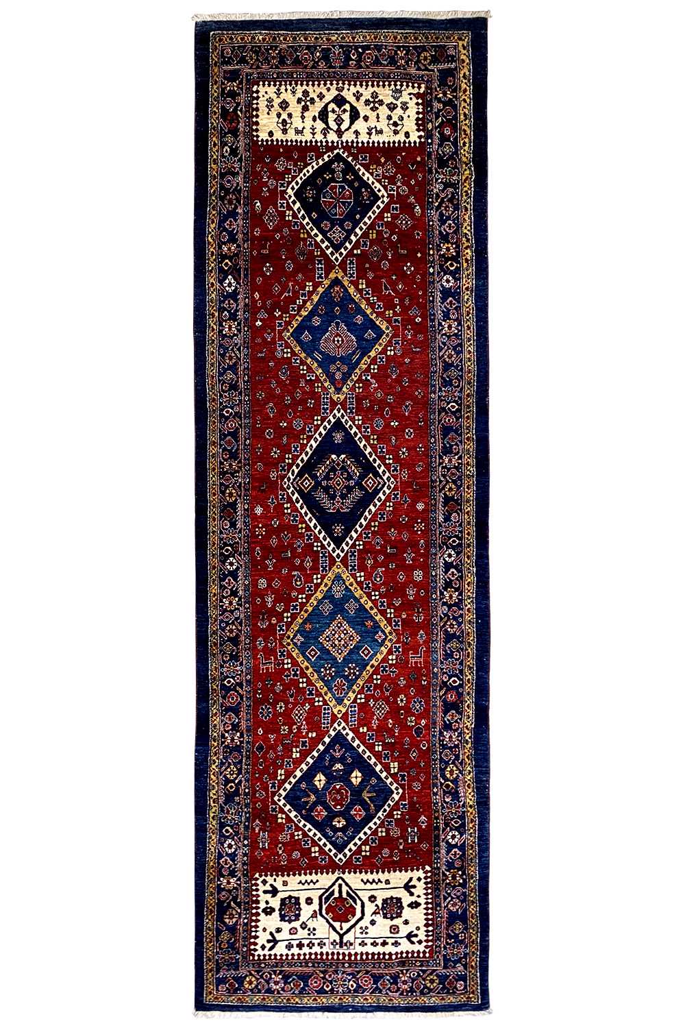 Narrow Oriental runner rug with a red field, dark blue border, and diamond motifs