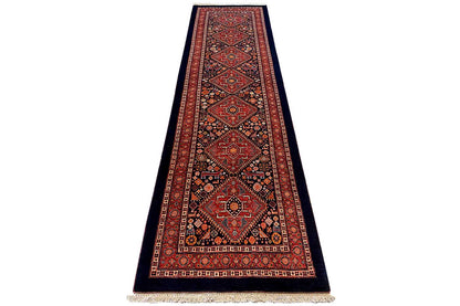 Narrow oriental rug runner with a red border and rows of medallions, fringed edges