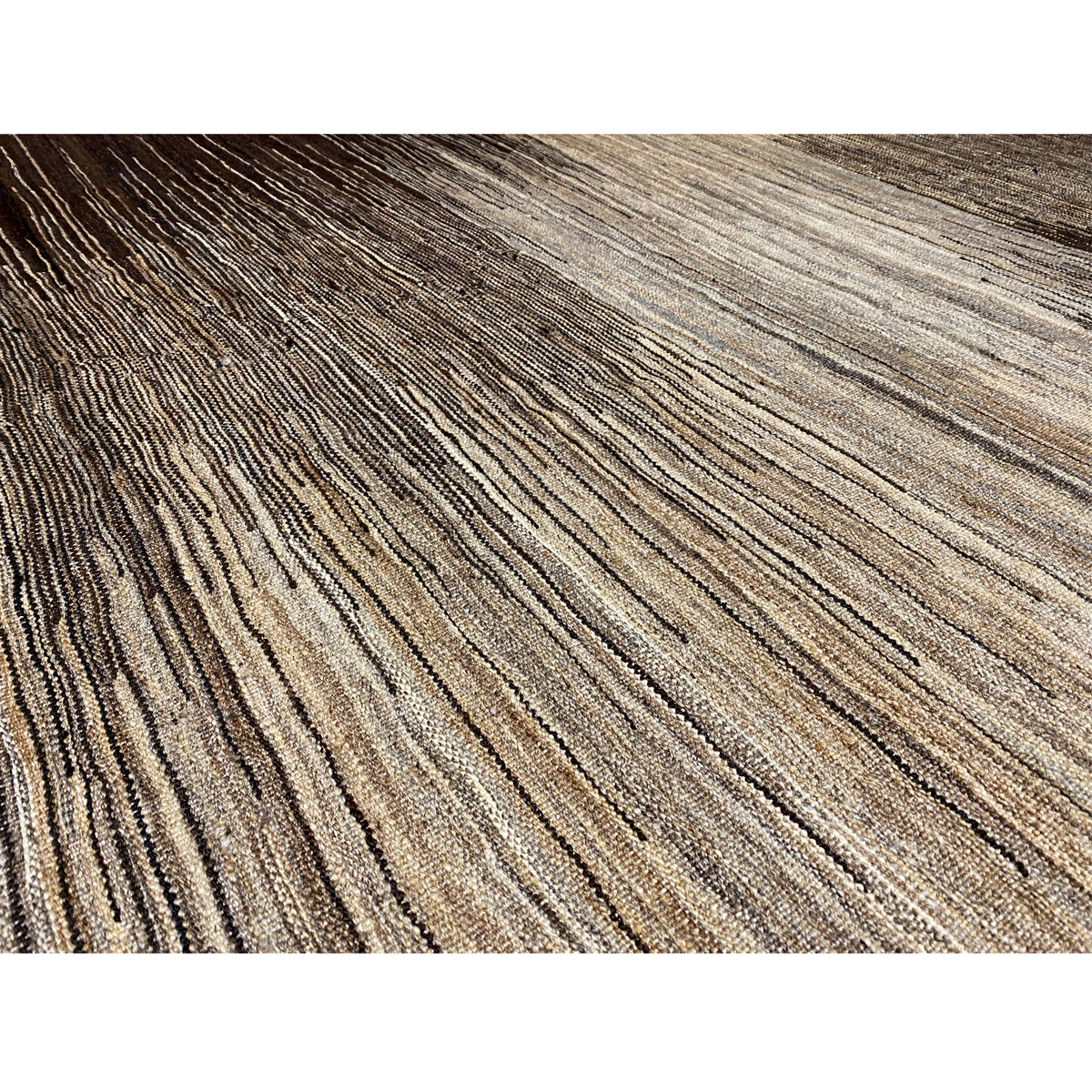 Close-up of a kilim: fine stripes in light beige, brown, and dark brown, with an even weave structure