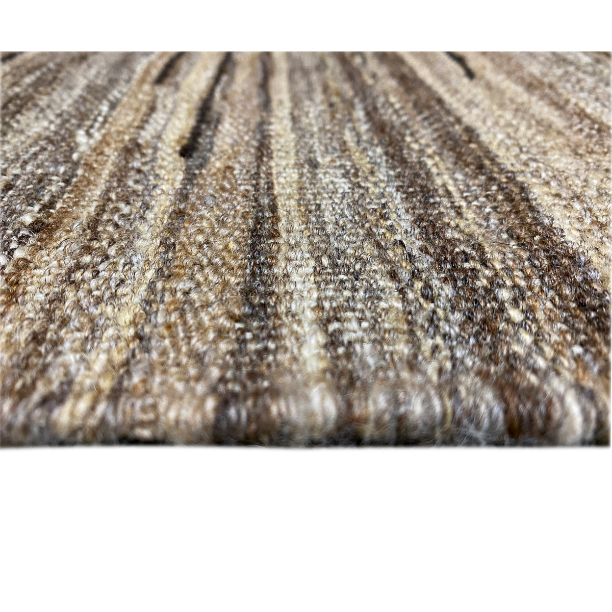Close-up of the web structure of a kilim rug in beige and brown tones with fine fibers