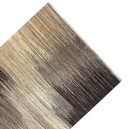 Kilim rug corner viewed at an angle, light beige and dark brown, frayed edge