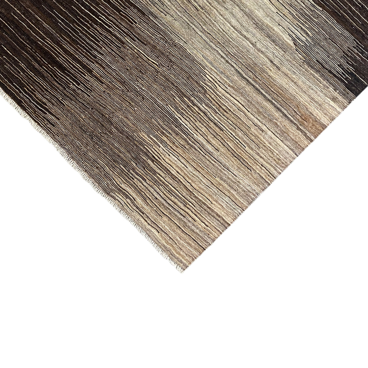 Kilim rug detail with a frayed edge, beige and dark brown striped pattern
