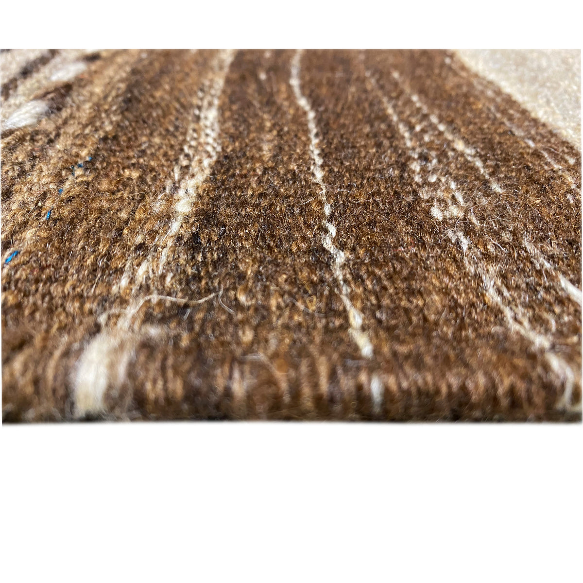 Kilim rug detail of the wool surface with brown and beige fibers