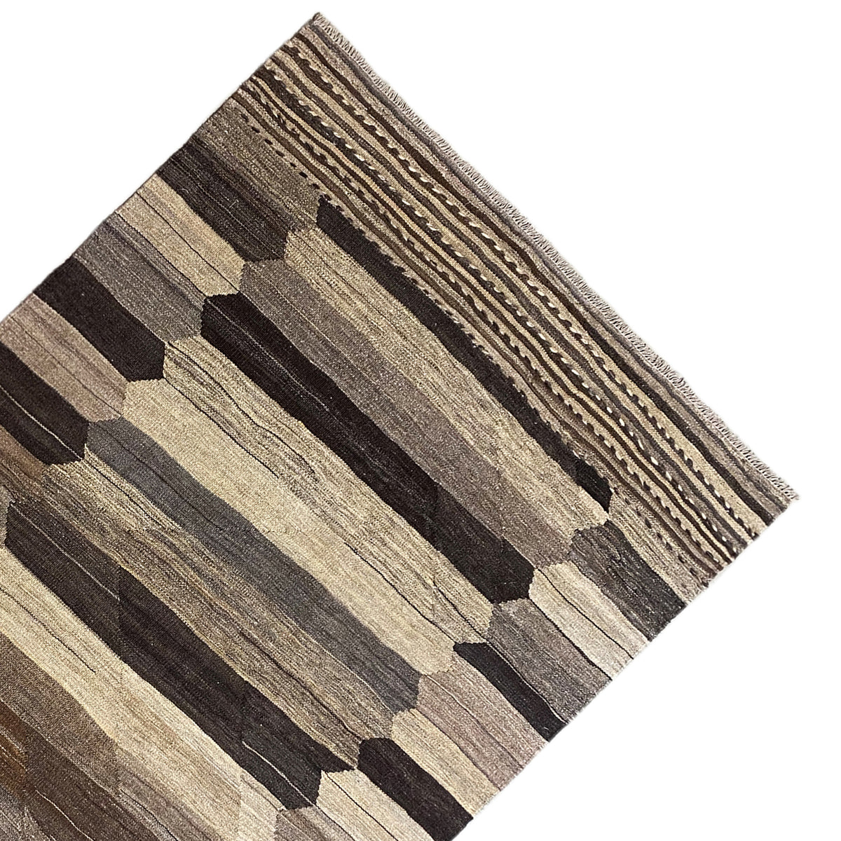 Close-up: kilim with a square and stripe pattern in dark brown, gray, and beige