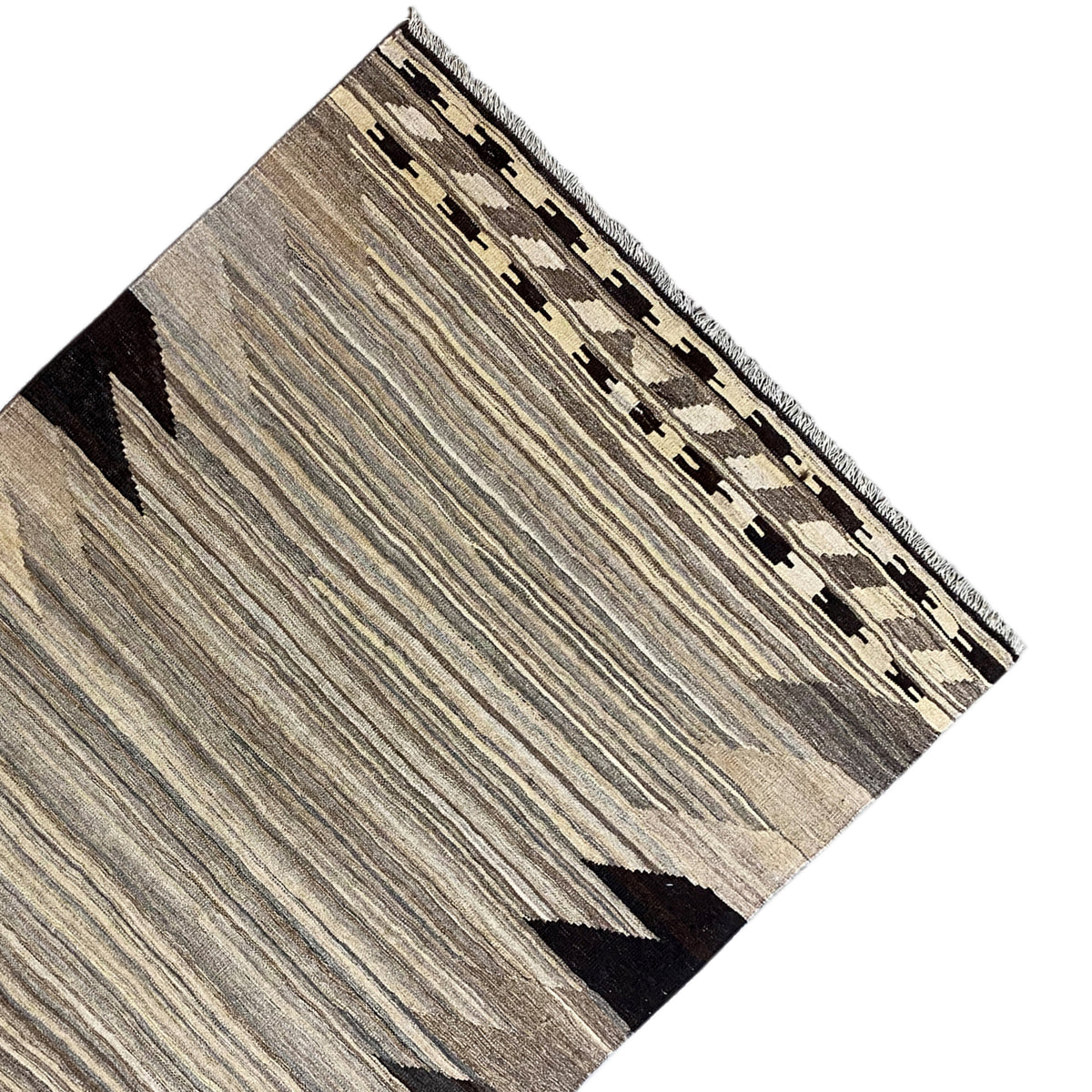 Kilim rug corner with a border of squares, gray stripes, and black triangles