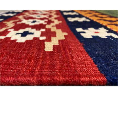 Kilim rug with a woven pile, red and blue areas, and a visible weave structure