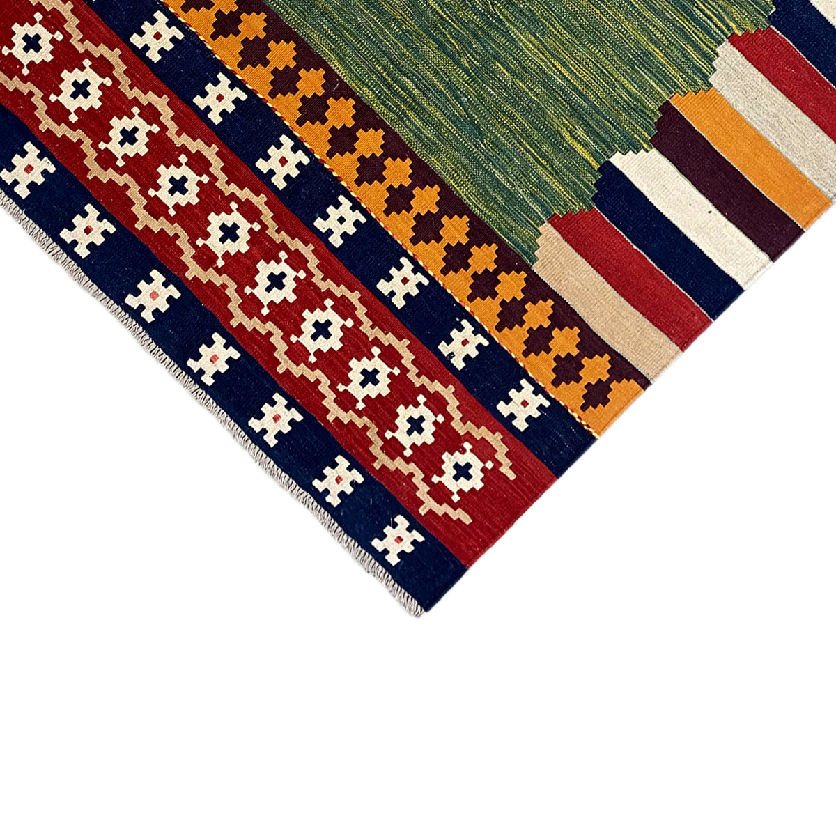 Kilim rug edge with fringe and geometric motifs in red, blue, and beige