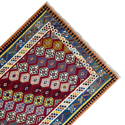Kilim rug corner in perspective: border with small squares, red central field, blue and yellow