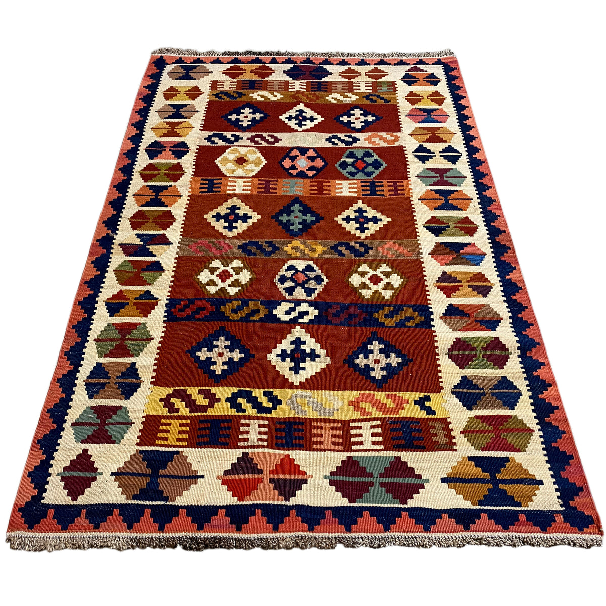 Rectangular kilim rug with geometric motifs and fringes along the edge.