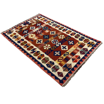 Kilim rug viewed diagonally: geometric pattern in warm and cool colors.