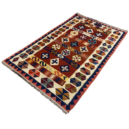 Kilim rug viewed from above with a clear border and colorful symbols.