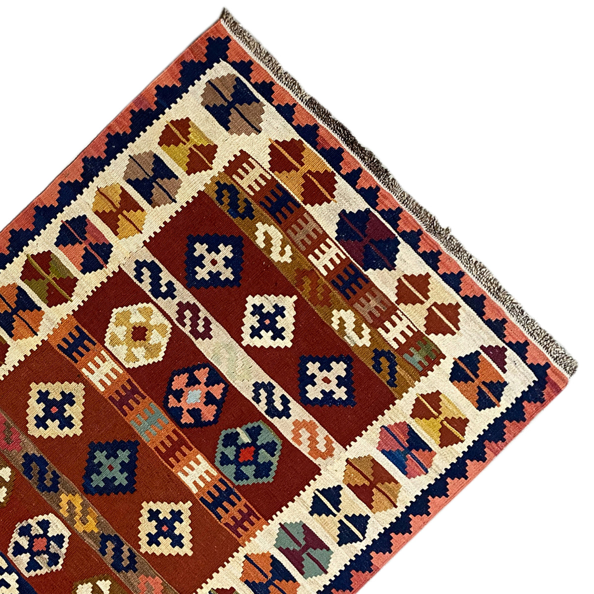 Kilim rug viewed diagonally, with many squares, diamonds, and decorative bands.