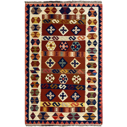 Kilim rug with a geometric pattern, border, and multicolored palette.
