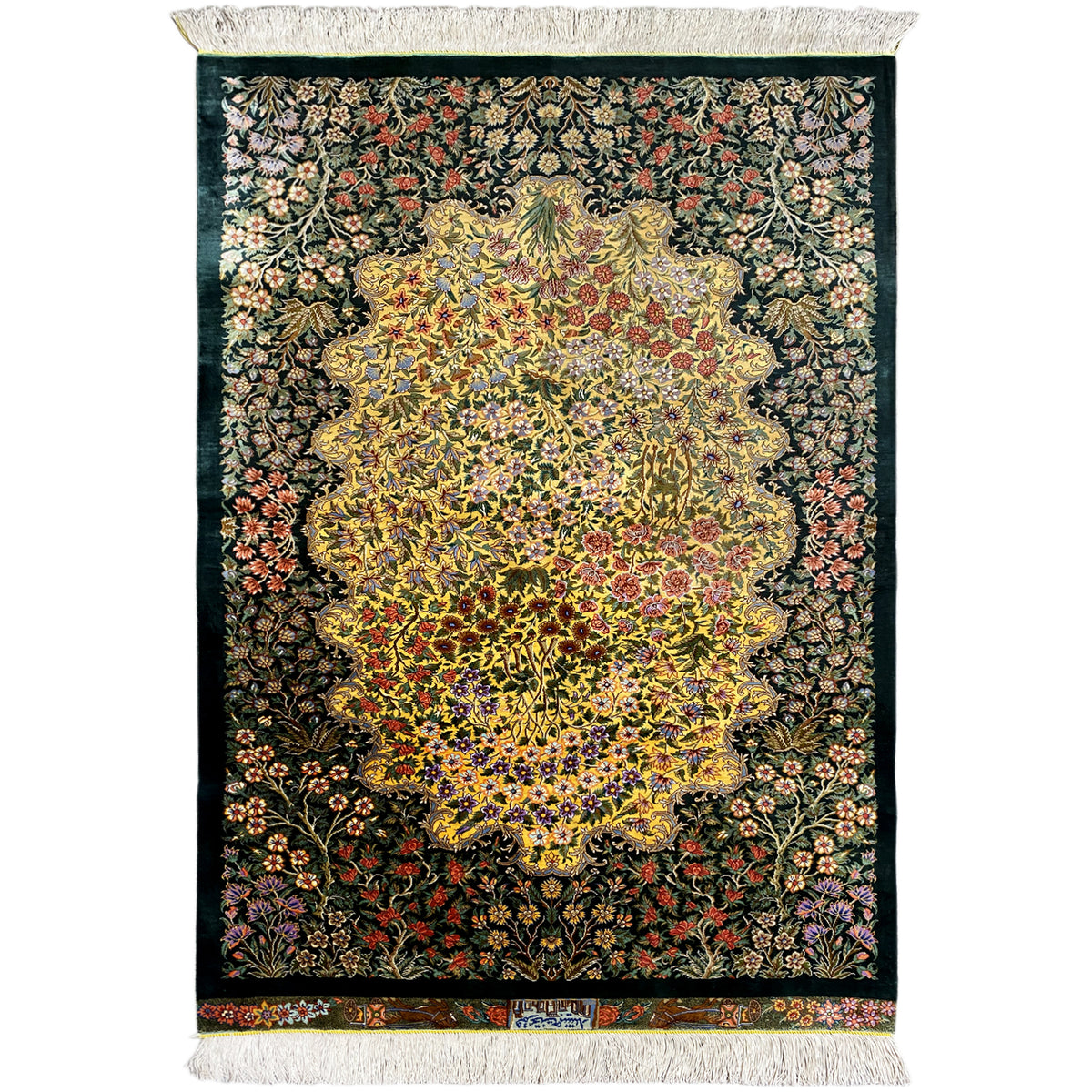 Rectangular silk rug with an intricate floral pattern and light-colored fringe