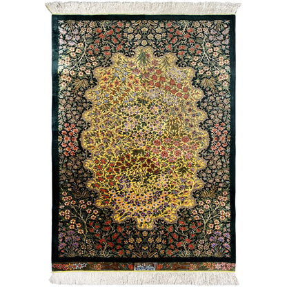 Rectangular silk rug with an intricate floral pattern and light-colored fringe