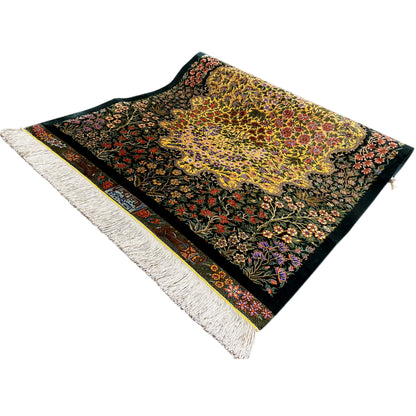 Silk rug with colorful floral embroidery on a dark background, with fringes