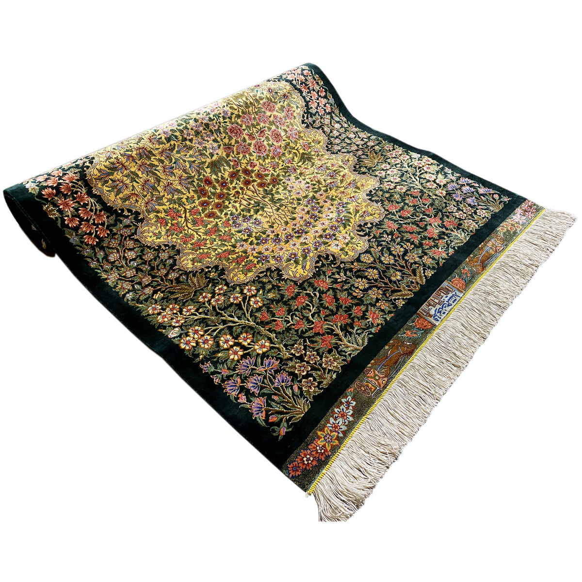 Square silk rug with fringes, a dark background, and a colorful floral pattern