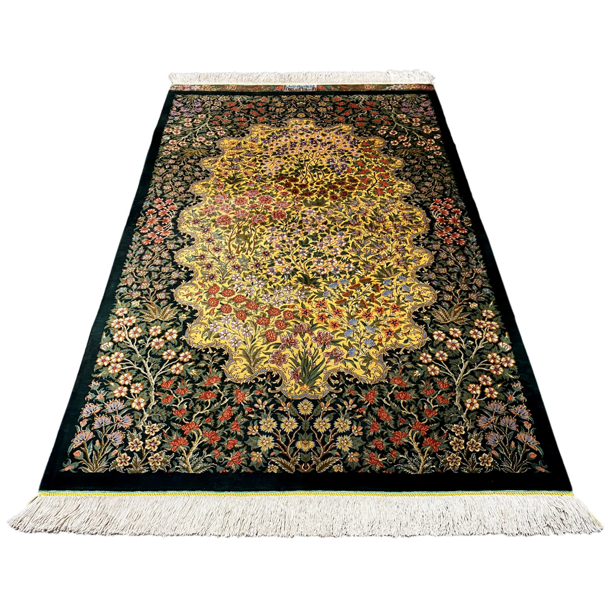 Rectangular silk rug with a large yellow pattern, dark green and red flowers, fringes