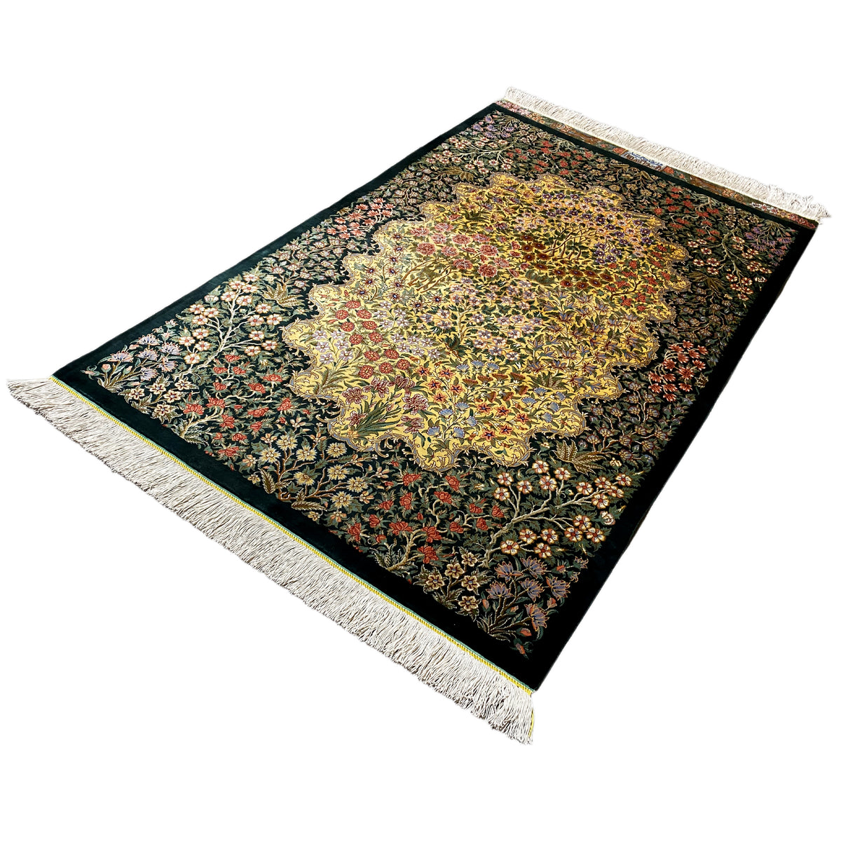 Rectangular silk rug with a yellow floral medallion, dark green, colorfully embroidered, fringed