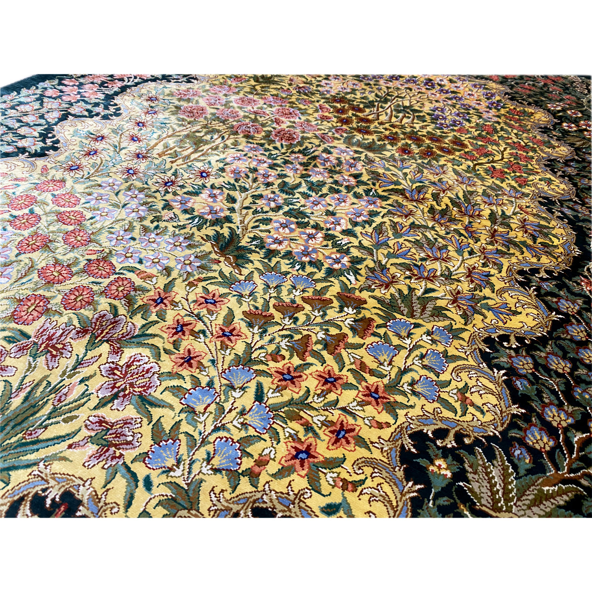 Close-up of silk carpet: dense floral pattern in blue, yellow, red and green
