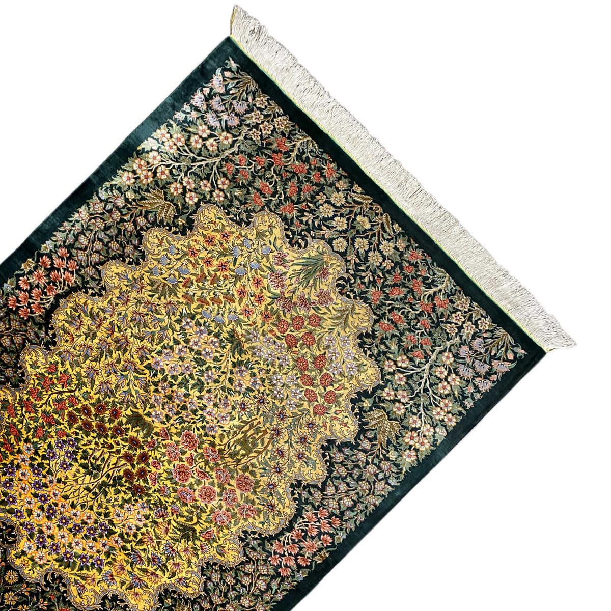Corner silk rug with a yellow floral medallion, dark green, white fringe